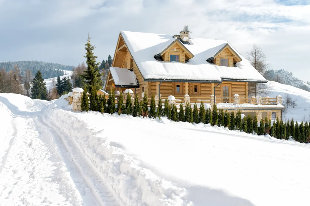 Wooden house in the mountains surrounded by deep snow